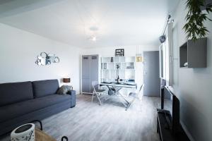 a living room with a couch and a table at Appart Coeur de Rouen-Gare in Rouen