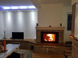 a fireplace in a living room with a fire place at Lakeview rest Home in Konjic