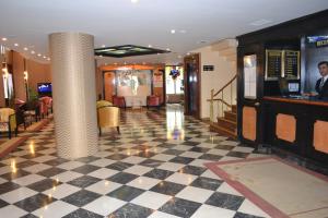 a lobby with a checkered floor and a column at Tayhan Hotel in Istanbul