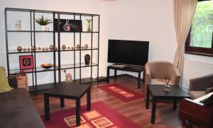 a living room with a couch and a television at Casa de la mare in Constanţa