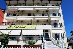 a building with a sign for the kilimanjaro inn at Adriani Inn in Paralia Katerinis