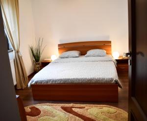 a bedroom with a bed with two pillows on it at Casa de la mare in Constanţa