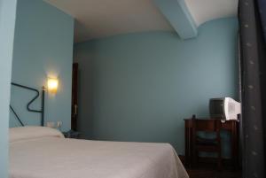 Postel nebo postele na pokoji v ubytování Hotel Los Laureles