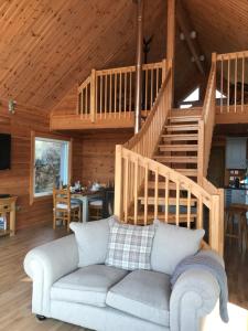 a living room with a couch and a staircase at The Hatchery in Tolstachaolais