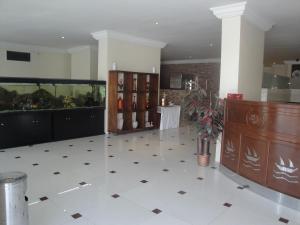 a large room with a white tiled floor and a counter at Marina Royal Hotel Suites in Kuwait