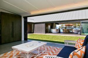 a living room with a couch and a table at The Point Luxury Villa in Taupo