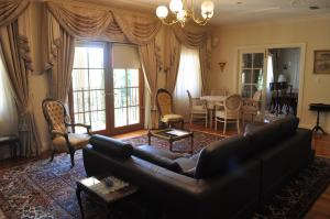 a living room with a couch and a dining room at The Residence at Barossa Chateau in Lyndoch