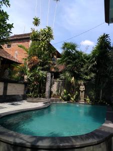 a swimming pool in the middle of a yard at Pondok Bambu Homestay in Ubud