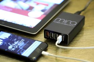 two cell phones hooked up to a charger at The Mira Hong Kong in Hong Kong
