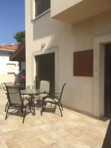 a patio with a table and chairs in a house at Artemis House in Limassol