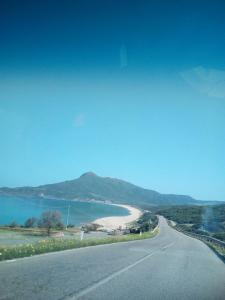 a road with a beach and a body of water at AL MARE, AL SOLE, SI', ma nella CASA DEL MINATORE in Buggerru