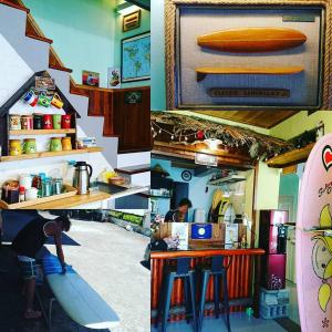 a man standing at a counter with a surfboard in a room at On Board Hostel in Manzhou