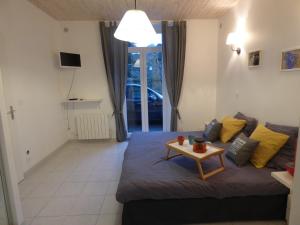 a living room with a couch and a table at La Maison du Palus in Plouha