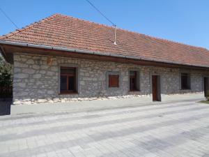 a small stone building with a red roof at Gyöngyszemvendégház in Sátoraljaújhely