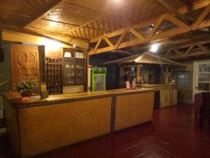 a bar in a restaurant with a counter top at Hotel Pison in Rantepao