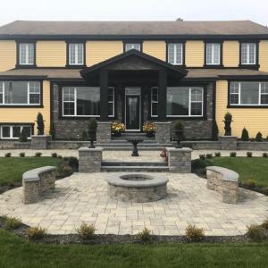 a large yellow house with a fountain in front of it at Castle Landing in Placentia