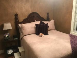 a stuffed dog sitting on a bed with pillows at Castle Landing in Placentia