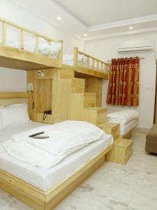 a bedroom with two bunk beds and a staircase at Friends Hostel by Backpackers Heaven- New Delhi Railway Station - Paharganj in New Delhi