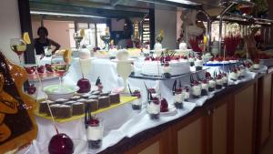 a buffet with cakes and desserts on a table at Side Palm D'or Hotel in Side