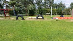 a park with a playground with two play equipment at Campingplatz Blauer See in Lünne