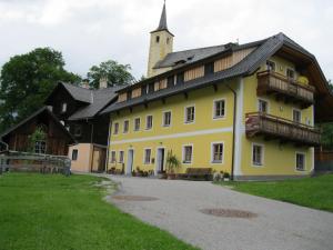 a large yellow building with a tower on top of it at David Appartments in Mauterndorf