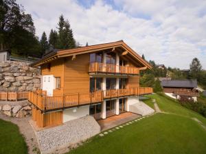 a large wooden house with a large deck at Das Hillside Maria Alm Hintermoos in Maria Alm am Steinernen Meer