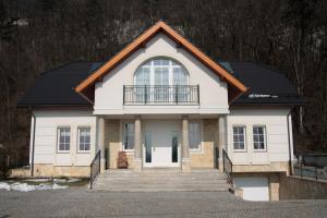 een wit huis met een zwart dak bij Villa Julia in Krakau