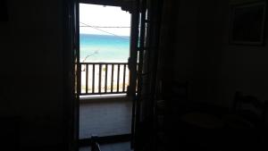 an open door with a view of the ocean at House Kosmas on the beach in Sarti