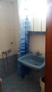 a bathroom with a sink and a shower at House Kosmas on the beach in Sarti