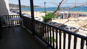 a balcony with a view of a beach at House Kosmas on the beach in Sarti