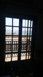 a view of a building from a window at House Kosmas on the beach in Sarti
