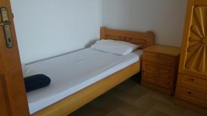 a small bedroom with a bed and a dresser at House Kosmas on the beach in Sarti