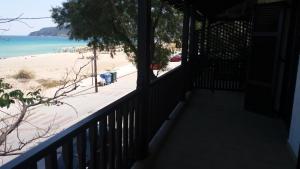 a balcony with a view of the beach at House Kosmas on the beach in Sarti