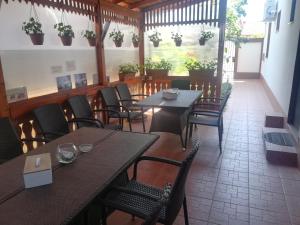 a restaurant with tables and chairs and plants on the wall at Casa Diana in Sulina