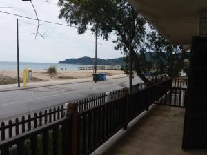 a view of a beach from a fence at House Kosmas on the beach in Sarti