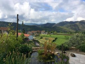 a view of a farm with mountains in the background at Collina di Sopra in Tresana