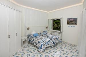 A bed or beds in a room at Ambra Sorrento Suites Short Rent