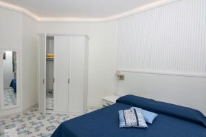 A bed or beds in a room at Ambra Sorrento Suites Short Rent