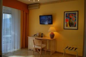 Zimmer mit einem Tisch, Stühlen und einer Lampe in der Unterkunft La Riserva di Castel d'Appio- Charme & Relax in Ventimiglia