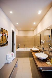 a bathroom with two sinks and a bath tub at Delle Vittorie Luxury Rooms&Suites in Palermo