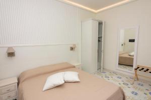 A bed or beds in a room at Ambra Sorrento Suites Short Rent