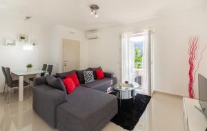 a living room with a couch and a table at Green Paradise Apartments in Mokošica