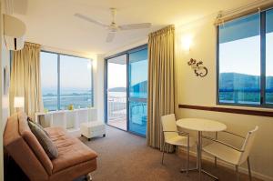 a living room with a couch and a table at at Whitsunday Vista Holiday Apartments in Airlie Beach