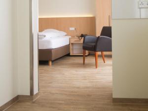 A bed or beds in a room at Hotel & Restaurant Wefers