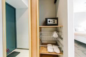 a walk in closet with a towel rack and a mirror at Apartments Statskij Sovetnik in Saint Petersburg