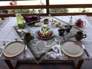a wooden table with plates of food on it at Galambos Pincészet in Abaújszántó +16 photos