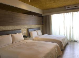 Postel nebo postele na pokoji v ubytování R8 Eco Hotel