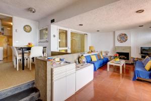 a living room with a blue couch and a table at Terrazza Marina in Porto Santo Stefano