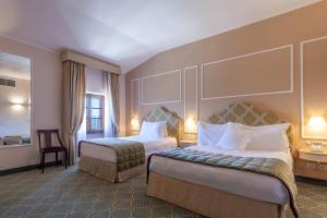 Postel nebo postele na pokoji v ubytování Hotel Villa San Lucchese
