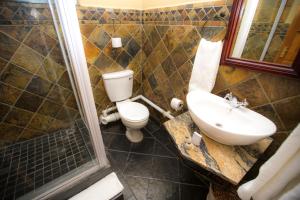 a bathroom with a toilet and a sink and a shower at Picanha Grill Guest House & Events Venue in Nigel +42 photos